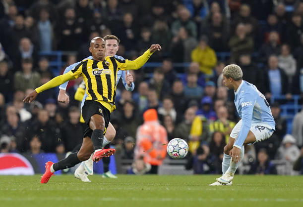 Manchester, England, 20th October 2026. Joao Mario of AEK Athens faces Rico Lewis of Manchester City during the Manchester City vs AEK Athens UEFA Champions League match at the Etihad Stadium, Manchester. Picture credit should read: Andrew Yates Sportimage EDITORIAL USE ONLY. No use with unauthorised audio, video, data, fixture lists, club league logos or live services. Online in-match use limited to 120 images, no video emulation. No use in betting, games or single club league player publications. SPI_028_AY_ManCity__Athens SPI-5090-0028