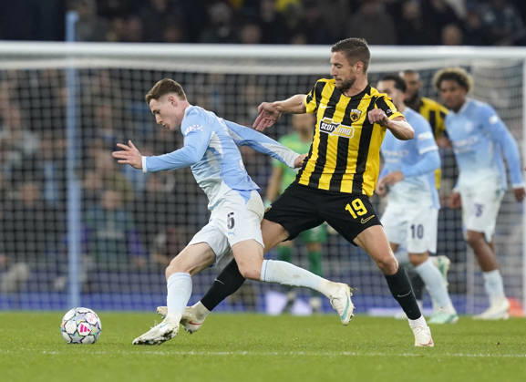 Manchester, England, 20th October 2026. Elliot Anderson of Manchester City tackled by Barnabas Varga of AEK Athens during the Manchester City vs AEK Athens UEFA Champions League match at the Etihad Stadium, Manchester. Picture credit should read: Andrew Yates Sportimage EDITORIAL USE ONLY. No use with unauthorised audio, video, data, fixture lists, club league logos or live services. Online in-match use limited to 120 images, no video emulation. No use in betting, games or single club league player publications. SPI_030_AY_ManCity__Athens SPI-5090-0030
