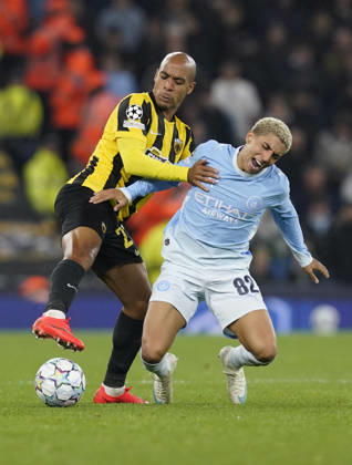 Manchester, England, 20th October 2026. Joao Mario of AEK Athens tackles Rico Lewis of Manchester City during the Manchester City vs AEK Athens UEFA Champions League match at the Etihad Stadium, Manchester. Picture credit should read: Andrew Yates Sportimage EDITORIAL USE ONLY. No use with unauthorised audio, video, data, fixture lists, club league logos or live services. Online in-match use limited to 120 images, no video emulation. No use in betting, games or single club league player publications. SPI_036_AY_ManCity__Athens SPI-5090-0036