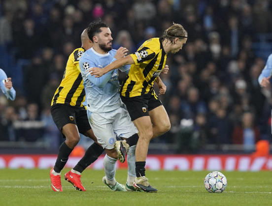 Manchester, England, 20th October 2026. Rayan Cherki of Manchester City tackled by Lovro Majer of AEK Athens (r) during the Manchester City vs AEK Athens UEFA Champions League match at the Etihad Stadium, Manchester. Picture credit should read: Andrew Yates Sportimage EDITORIAL USE ONLY. No use with unauthorised audio, video, data, fixture lists, club league logos or live services. Online in-match use limited to 120 images, no video emulation. No use in betting, games or single club league player publications. SPI_046_AY_ManCity__Athens SPI-5090-0046
