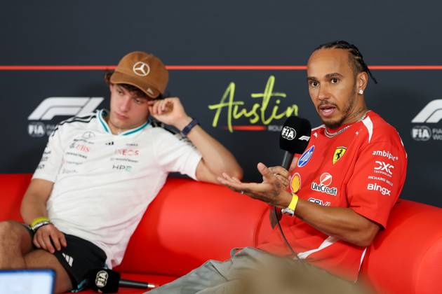 22nd October 2026; Circuit of the Americas, Austin, United States; Formula 1, United States Grand Prix, Arrivals Day; Lewis Hamilton (44) of Great Britain and Scuderia Ferrari HP speaks during an interview while Andrea Kimi Antonelli (12) of Italy and Mercedes-AMG PETRONAS Formula One Team sits behind VincentxCuono