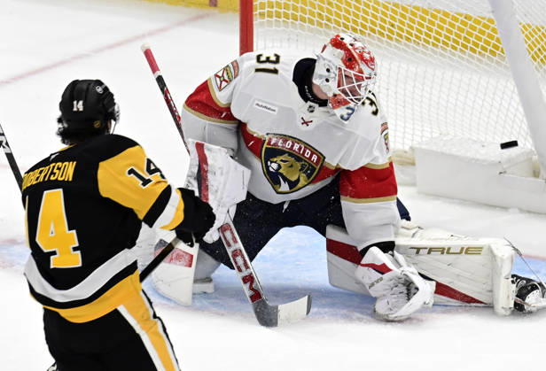 Pittsburgh Penguins left wing Nick Robertson (14) scores on Florida Panthers goalie Cooper Black (31) in the first period at PPG Paints Arena in Pittsburgh on Thursday, October 22, 2026.  PIT2026102201 ARCHIExCARPENTER