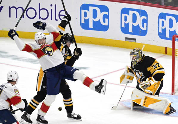 Florida Panthers center Eetu Luostarinen (27) and Pittsburgh Penguins defenseman Kaedan Korczak (6) collides in front of Pittsburgh Penguins goaltender Arturs Silovs (37) during the second period at PPG Paints Arena in Pittsburgh on Thursday, October 22, 2026.  PIT2026102207 ARCHIExCARPENTER