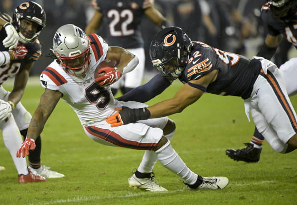 New England Patriots running back Corey Kiner (9) is tackled by Chicago Bears defensive end Daniel Hardy (92) at Soldier Field in Chicago on Thursday, October 22, 2026. The Bears defeated the Patriots 30-24. CHI20261022139 MARKxBLACK