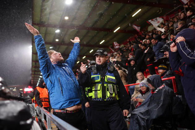 Bournemouth v AC Milan 22 October 2026, Bournemouth - UEFA Europa League - Bournemouth v AC Milan - A Bournemouth fan attempts to rile up the Curva Sud but a police officer stops him - Photo: Jacques Feeney Offside. Bournemouth UK Copyright: xJacquesxFeeneyx xOffsidexOffside