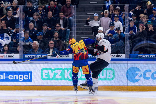 Check von Topscorer Vinzenz Rohrer (EV Zug) gegen Fabian Heldner 91 (Lausanne HC) - 23.10.2026 - National League, Regular Season, Eishockey, OYM hall, Zug: EV Zug - Lausanne HC . (Bild von Copyright: xJustPictures.ch PhilippxHegglinx