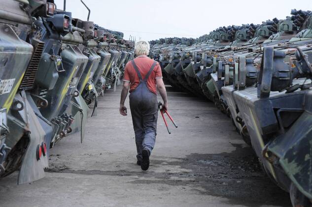 Mitarbeiter Marco Schwinn zwischen zu verschrottenden Panzern in der Battle Tank