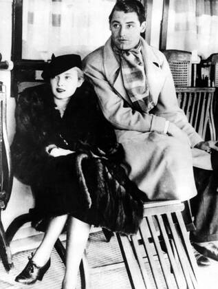 Nov 23, 1933 - Los Angeles, CA, USA - British-born actor CARY GRANT (born Archibald Leach) with his future wife VIRGINIA CHERRILL before leaving to England. Grant escaped his humble Bristol environs and unstable home life by joining an acrobatic troupe, where he became a stilt-walker. Numerous odd jobs kept him going until he tried acting, and, after moving to the United States, he managed to lose his accent, developing a clipped mid-Atlantic speaking style uniquely his own. He was noted as perhaps the foremost exemplar of the debonair leading man, handsome, witty and charming. He was named the second Greatest Male Star of All Time of American cinema by the American Film Institute. Los Angeles USA - ZUMAk09