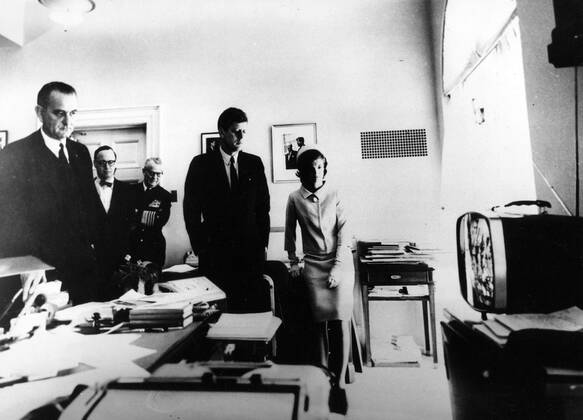 May 05, 1961 - Washington, District of Columbia, USA - Born into a rich, politically connected Boston family JOHN F. KENNEDY was the youngest person elected U.S. President and the first Roman Catholic to serve in that office. For many observers, his presidency came to represent the ascendance of youthful idealism in the aftermath of World War II. The promise of this energetic and telegenic leader was not to be fulfilled, as he was assassinated near the end of his third year in office. His shocking death stood at the forefront of a period of political and social instability in the country and the world. PICTURED: JOHN F. KENNEDY (middle), his wife JACQUELINE and vice president LYNDON B. JOHNSON following Alan B. Shepard, the first American, to travel into space on TV. Washington USA - ZUMAk09