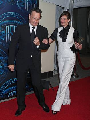 Tom Hanks and Julia Roberts arrive on the red carpet after Roberts received the Board of Governors Award during the 25th annual American Society of Cinematographers Awards in the Hollywood section of Los Angeles on February 13, 2011.  LAP20110213723