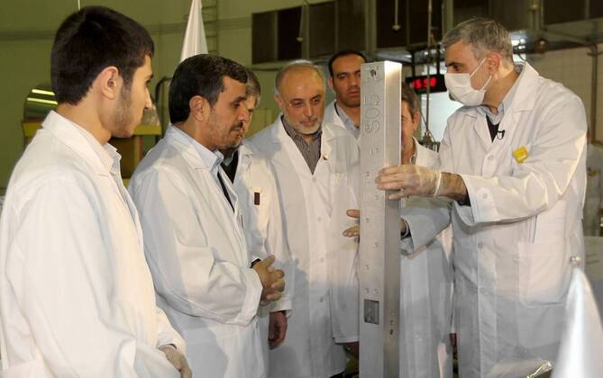 A handout picture released by the Iranian President Mahmoud AhmadinejadâÄ?s official website shows Ahmadinejad (2nd,L) and Iranian Foreign Minister Ali Akbar Salehi (C) visiting TehranâÄ?s nuclear reactor during the unveiling ceremony on February 15, 2012 in Tehran, Iran. Iran simultaneously unveiled three new nuclear projects on Wednesday.  TEH20120215102