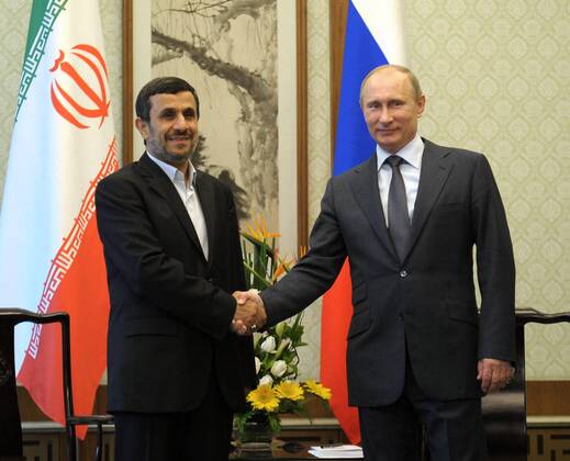 ITAR-TASS: BEIJING, CHINA. JUNE 7, 2012. Iran s President Mahmoud Ahmadinejad (L) and Russia s President Vladimir Putin shake hands during their meeting on the sidelines of the 12th Shanghai Cooperation Organization Summit (SCO) in Beijing.  Highlight RE10072F