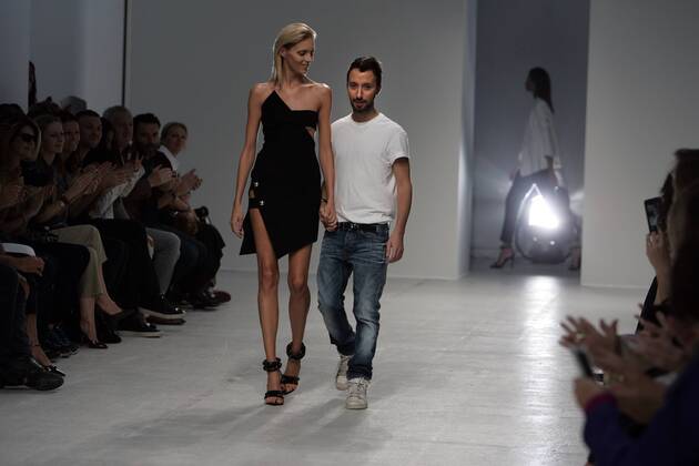 A model takes to the catwalk during Anthony Vaccarello s show as part of the Spring-Summer 2014 Fashion Week in Paris, France, on September 24, 2013.  PAR20130924201