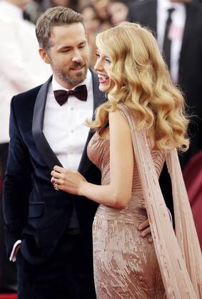 Blake Lively and Ryan Reynolds arrive on the red carpet at the Costume Institute Benefit celebrating the opening of Charles James: Beyond Fashion and the new Anna Wintour Costume Center at the Metropolitan Museum of Art in New York City on May 5, 2014.  NYP20140505148