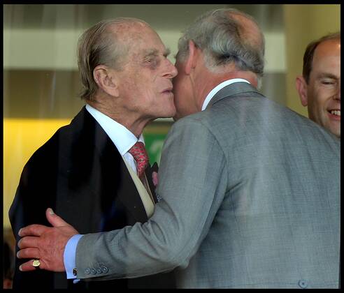 Image ©Licensed to i-Images Picture Agency. 18 06 2014. Ascot, United Kingdom. The Duke of Edinburgh kisses his son The Prince of Wales in the Royal Box on Day 2 of Royal Ascot at Ascot Racecourse. AndrewxParsonsx xi-Images IIM-2483-0036