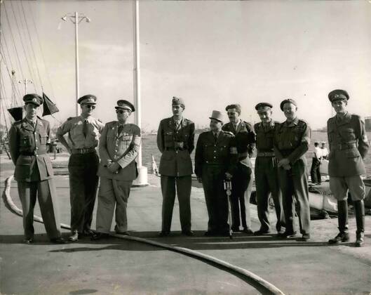 Nov. 11, 1956 - U.N. Observers arrive in Port Said.: Picture received in London today from Port Said. The United Nations is observes from any U.N. countries arrived in Port Said by landing craft. They had come to observe the Cease Fire agreement between Anglo-French and Egyptian forces. Photo shows afters they had arrived in Port Said they drove to the Allied Headquarters at Suez House. There they met The Task Force Commander General Sir Hugh Stockwell. Hore are a group of the observes at Suez House with the Canal in the background.  - ZUMAk09