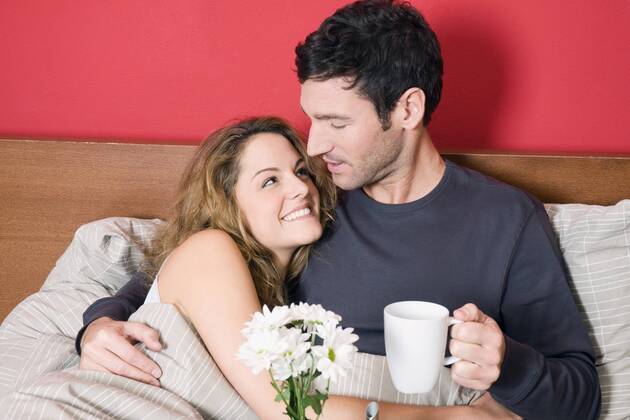 Young couple having breakfast in bed model released property released NHF00983