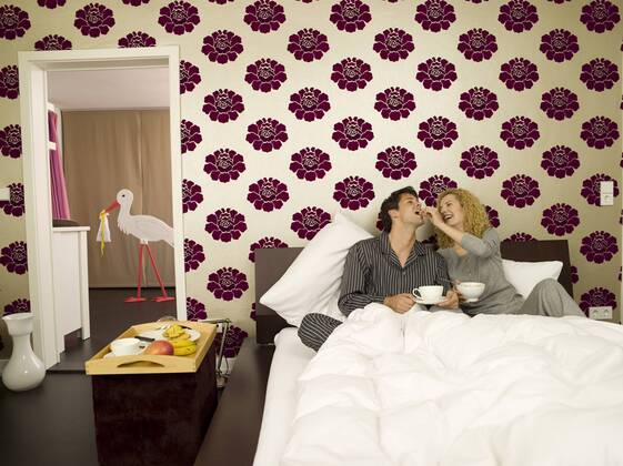 Young couple having breakfast in Bed model released property released WESTF06683