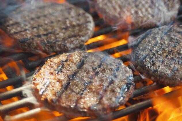 USA, Texas, Burger patties on barbecue grate  ABAF000222