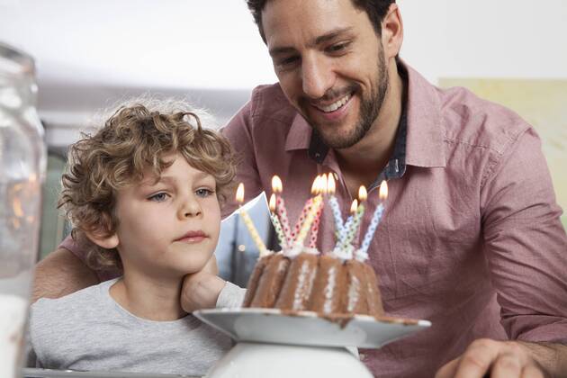 Father and son with birthday cake model released Symbolfoto property released  RBF002425