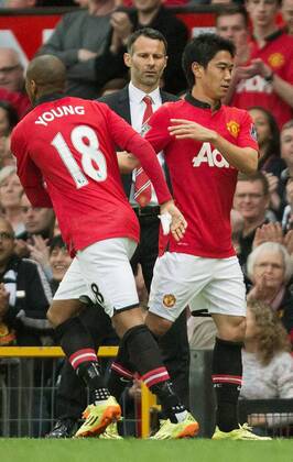 MANCHESTER, United Kingdom - Manchester United midfielder Shinji Kagawa (R) is replaced by Ashley Young (18) during the second half of an English Premier League soccer match against Norwich City in Manchester on April 26, 2014. Standing behind the players is Manchester United s interim manager Ryan Giggs. Manchester United won 4-0. 0427001
