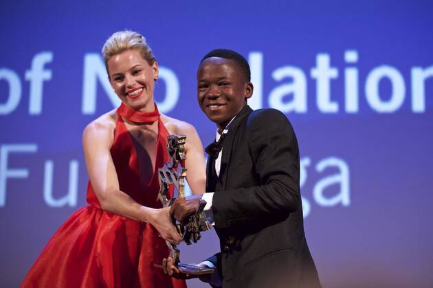 (150912) -- VENICE, Sept. 12, 2015 -- Actor Abraham Attah (R) receives the Marcello Mastroianni Award to a Young Actor from a jury member Elizabeth Banks, for his role in Beasts of No Nations , during the award ceremony at the 72nd Venice Film Festival, at the Lido of Venice, Italy, Sept. 12, 2015. ) ITALY-VENICE-FILM-FESTIVAL-72ND-AWARD JinxYu 