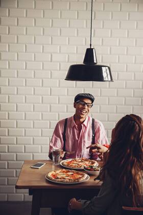 Young couple eating pizza in restaurant model released Symbolfoto property released CHAF001283