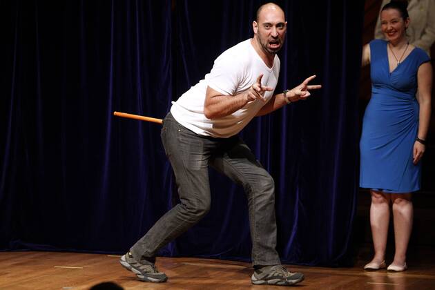 Bruno Grossi of the Universidad de chile, Santiago, demonstrates the research he and his team did to win the 2015 Ig Nobel Prize in Biology for observing that when you attach a weighted stick to the rear end of a chicken, the chicken then walks in a manner similar to that in which dinosaurs are thought to have walked, at the awards ceremony at Harvard University in Cambridge, Massachusetts on September 17, 2015. The prizes which are awarded by the Annals of Improbable Research are intended to celebrate the unusual, honor the imaginative and spur people s interest in science, medicine, and technology.  BOS2015091705 MATTHEWxHEALEY