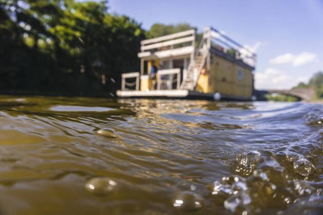 Water surface with house boat in background model released Symbolfoto property released  FMKF001901