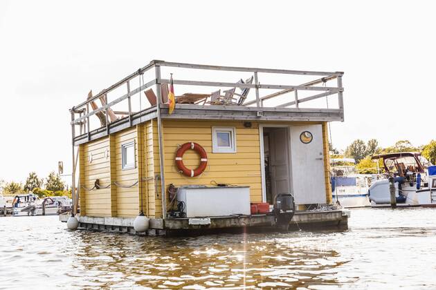 Legs of a couple on roof terrace on a house boat model released Symbolfoto property released  FMKF001933