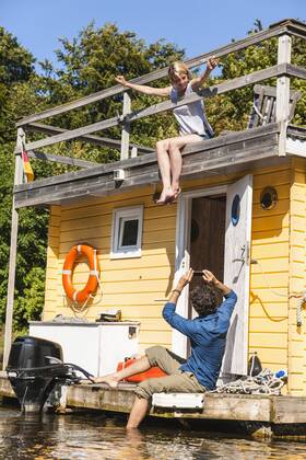 Couple having a trip on a house boat taking a picture model released Symbolfoto property released  FMKF001987