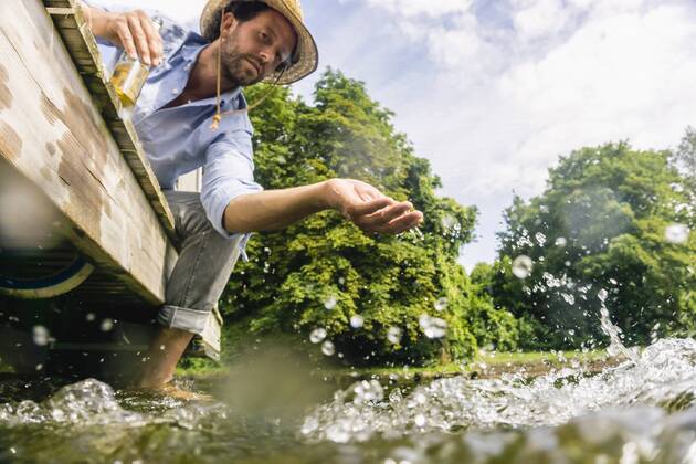 Man on a house boat refreshing himself model released Symbolfoto property released  FMKF001989