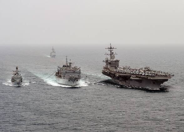 March 18, 2015 - Uss Carl Vinson, United States of America - U.S. Navy nuclear aircraft carrier USS Carl Vinson and the Royal Navy destroyer HMS Kent (left) conduct a replenishment-at-sea with the Military Sealift Command combat support ship USNS Rainier (center) March 18, 2015 in the Arabian Sea. The group is deployed for Operation Inherent Resolve striking ISIS targets in Iraq and Syria. Uss Carl Vinson United States of America - ZUMAp138