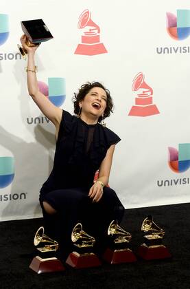 Natalia Lafourcade poses in the press room with the awards for best alternative music album, best alternative song, record of the year, song of the year and best engineered album for Hasta La Raiz during the 16th Annual Latin Grammy Awards at the MGM Grand Garden Arena in Las Vegas, Nevada on November 19, 2015.  LAV20151119619 JIMxRUYMEN