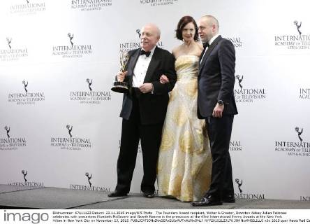 The Founders Award recipient, Writer & Creator, Downton Abbey Julian Fellowes celebrates with presenters Elizabeth McGovern and Gareth Neame in the pressroom at the 43rd International Emmy Awards at the New York Hilton in New York City on November 23, 2015.  NYP20151123176 JOHNxANGELILLO
