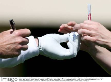 March 13, 2013 - Palm Harbor, Florida, U.S. - DOUGLAS R. CLIFFORD TIMES.Jim Furyk, left, hands a signed golf ball to a fan at the 16th tee Wednesday (3 13 13) while competing in the Tampa Bay Championship Pro-Am at Innisbrook s Copperhead Golf Course in Palm Harbor. - ZUMAs70