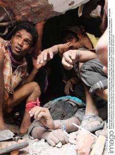 April 24, 2013 - Dhaka, Bangladesh - A garment worker lies trapped in the rubble. At least 80 people have been killed and many more are feared trapped after an eight-storey building collapsed in the Savar area on the outskirts of the capital, government officials say. - ZUMAa10