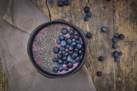 Blueberry smoothie with chia seeds in bowl, fresh blueberries LVF004501