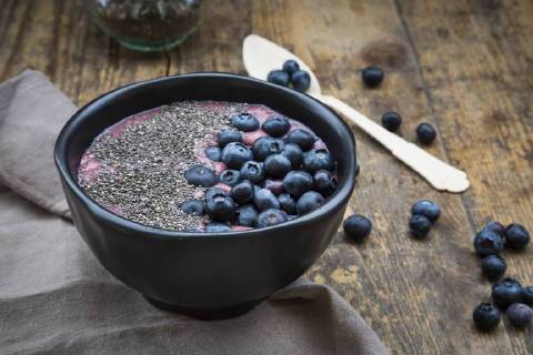 Blueberry smoothie with chia seeds in bowl, fresh blueberries LVF004503