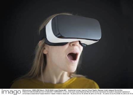 Astonished woman wearing Virtual Reality Glasses model released Symbolfoto  RBF004084
