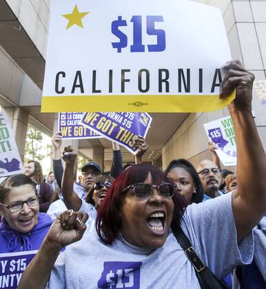 (160404) -- LOS ANGELES, April 4, 2016 -- Supporters celebrate after California Governor Jerry Brown signed landmark legislation SB 3 into law in Los Angeles, California, the United States, on April 4, 2016. Lawmakers in California on Thursday approved of raising minimum wage to 15 dollars an hour by 2022, making the state the first to mandate such a pay hike. ) U.S.-CALIFORNIA-LOS ANGELES-MINIMUM WAGE-LEGISLATION ZhaoxHanrong 