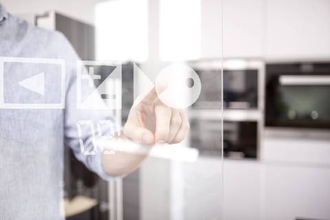 Man s hand using touchscreen of oven in his kitchen model released Symbolfoto property released  MFRF000545
