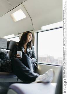 Young woman on train looking out of window model released Symbolfoto JRFF000634