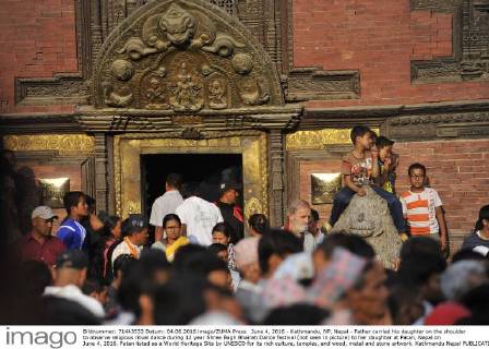 June 4, 2016 - Kathmandu, NP, Nepal - Father carried his daughter on the shoulder to observe religious ritual dance during 12 year Shree Bagh Bhairab Dance festival (not seen in picture) to her daughter at Patan, Nepal on June 4, 2016. Patan listed as a World Heritage Site by UNESCO for its rich culture, temples, and wood, metal and stone artwork. Kathmandu Nepal  - ZUMAn230