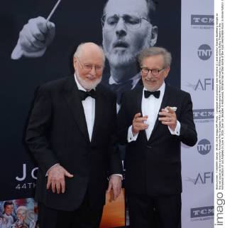 Composer and conductor John Williams (L) and director Steven Spielberg mingle on the red carpet as they arrive for American Film Institutes 44th Life Achievement Award gala tribute to Williams at the Dolby Theatre in the Hollywood section of Los Angeles on June 9, 2016. Over six decades in Hollywood, Williams has written some of the most memorable music in movie history. His 100-plus features have earned 50 Academy Award nominations (making him the most-nominated living person), winning five times. Williams also received 22 Grammys, seven BAFTAs, five Emmys, four Golden Globes, a Kennedy Center Honor and the National Medal of Arts. And then there are all those iconic themes, the ones everyone in the world knows.  LAP2016060906 JIMxRUYMEN