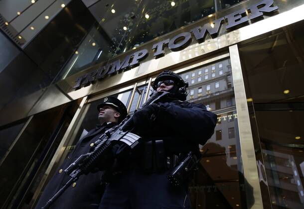 December 11, 2016 - New York, New York, United States of America - An armed NYPD police officer stands guard outside the entrance to Trump Tower on December 11, 2016 in New York City. U.S. President-elect Donald Trump is still holding meetings upstairs at Trump Tower as he continues to fill in key positions in his new administration. .Credit: Pool via CNP New York United States of America - ZUMAs152 20161211_zaa_s152_001