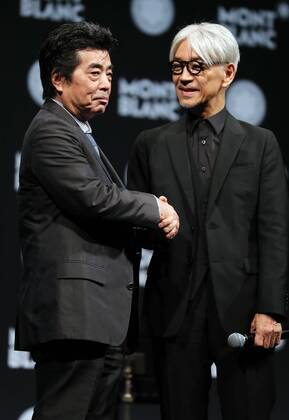 December 21, 2016, Tokyo, Japan - Japanese composer Ryuichi Sakamoto, a member of the Yellow Magic Orchestra (YMO) is celebrated from his friend and a Japanese author Ryu Murakami (L) after he received Montblanc de la Culture Arts Patronage Award in Tokyo on Wednesday, December 21, 2016. Sakamoto played his screen music Merry Christmas Mr. Lawrence with young musicians.  (lwxa006998)