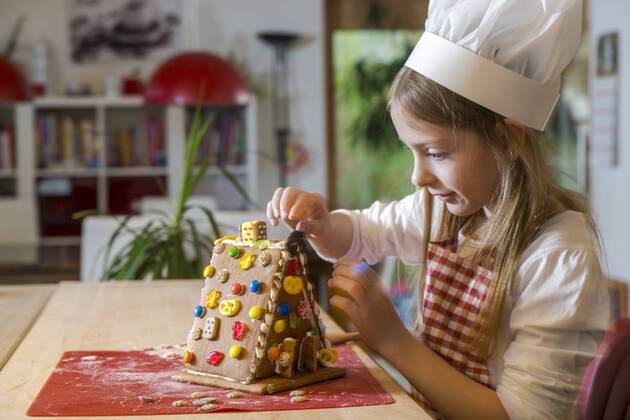 Girl garnishing gingerbread house model released Symbolfoto property released  SARF03091