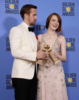 Ryan Gosling and Emma Stone, winners of the awards for Best Performance by an Actor and Actress in a Motion Picture Musical or Comedy respectively for La La Land appear backstage with their trophies during the 74th annual Golden Globe Awards at the Beverly Hilton Hotel in Beverly Hills, California on January 8, 2017.  LAP201701084012 JIMxRUYMEN
