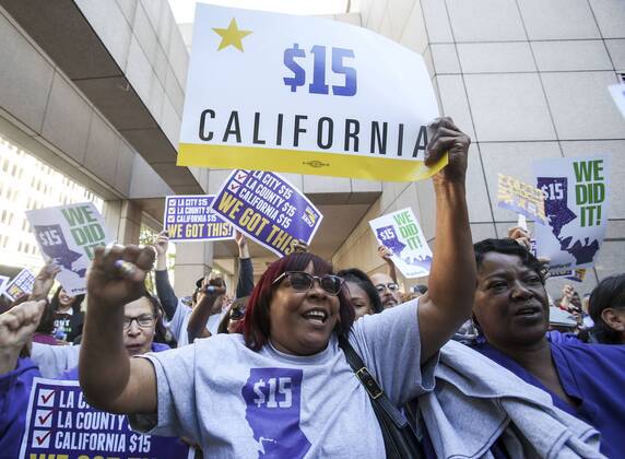 April 4, 2016 - Los Angeles, California, U.S - Supporters of the new minimum wage law celebrate after California Gov. Jerry Brown signed the landmark legislation Monday. California is the first state to commit to raising the minimum wage to 5 an hour by 2022. Los Angeles U.S. - ZUMAc68_ 20160404_zaf_c68_003